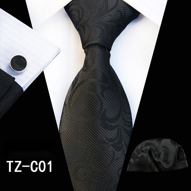 Red and green floral silk tie set with matching handkerchief and cufflinks, perfect for men's business or wedding accessories.