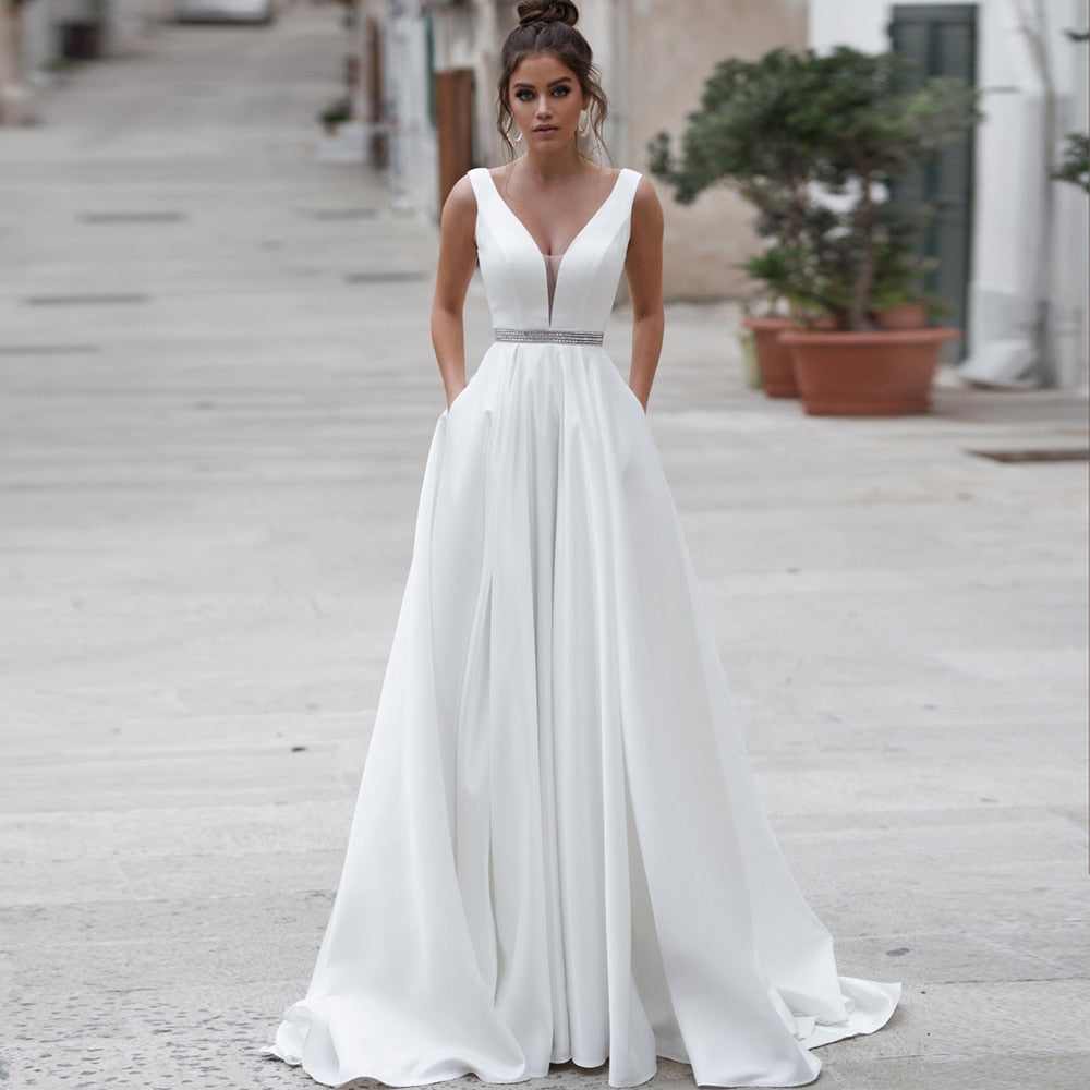 Elegant ivory satin wedding dress with V-neck, backless design, custom fit, by The Clothing Company Sydney.