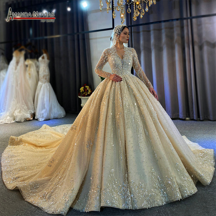 Luxury full pearls wedding dress with a long train, elegant design, and intricate pearl embellishments by The Clothing Company Sydney.