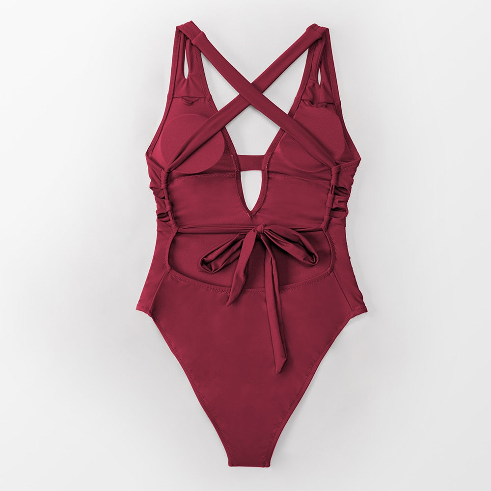 Solid dark blue one-piece swimsuit by The Clothing Company Sydney featuring a deep V-neck, backless design, and X-back style.