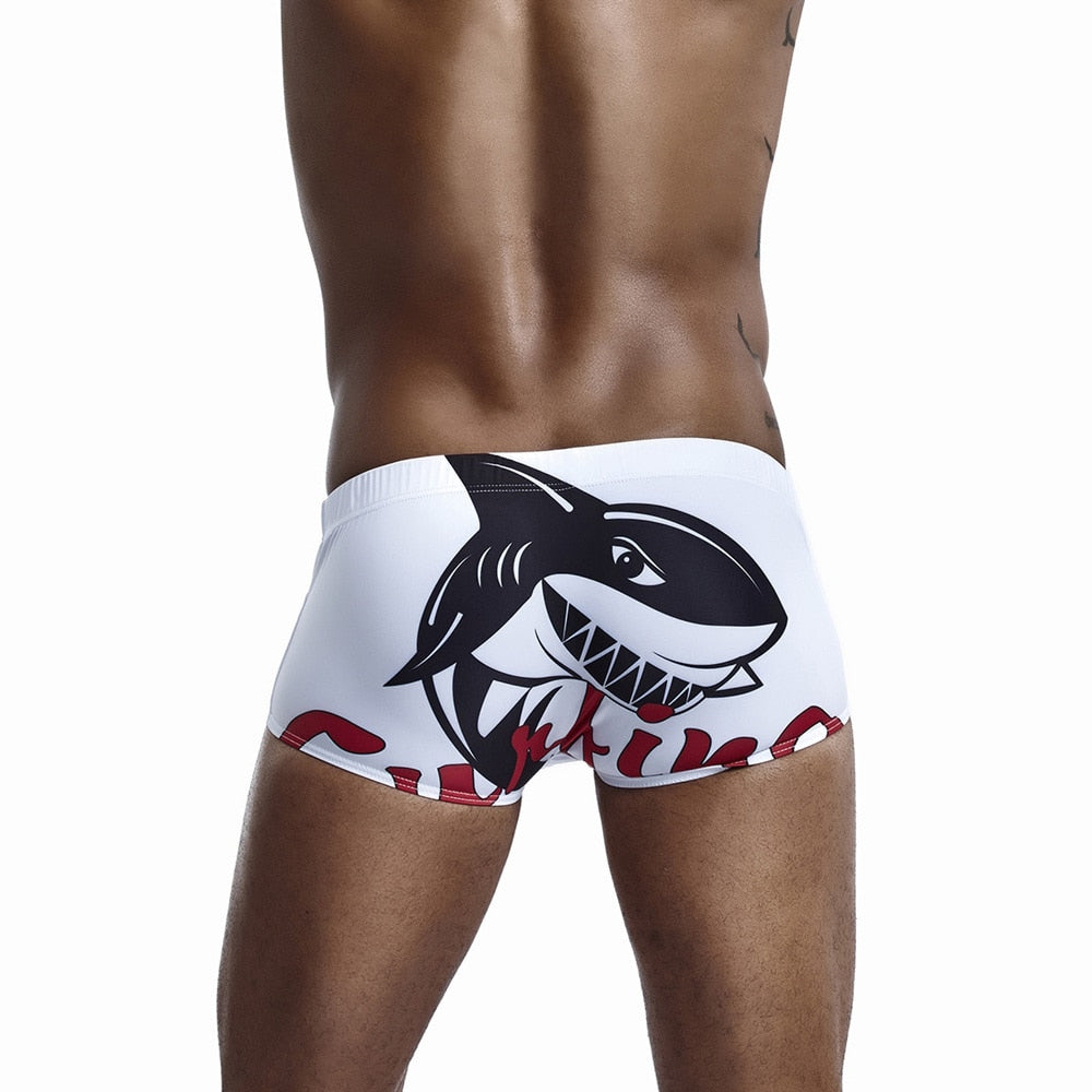 Men's shark pattern swim shorts by The Clothing Company Sydney, quick-dry swimming trunks for beach and surfing activities.