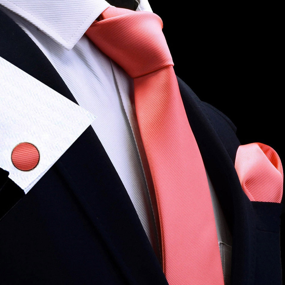 Three-piece men's silk tie set with red, gold, and purple ties, matching handkerchiefs, cufflinks, and accessories for formal attire.