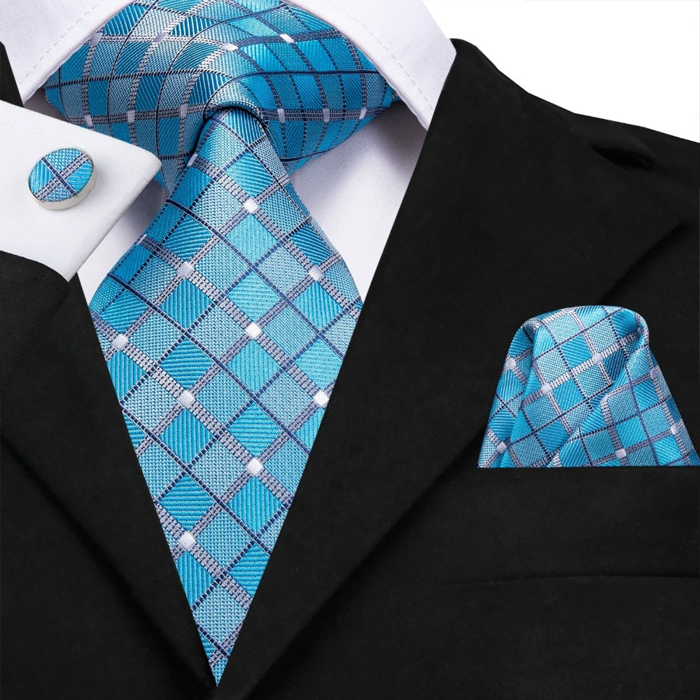 Light blue silk men's tie set includes plaid necktie, pocket square, and cufflinks, perfect for business or wedding accessories.