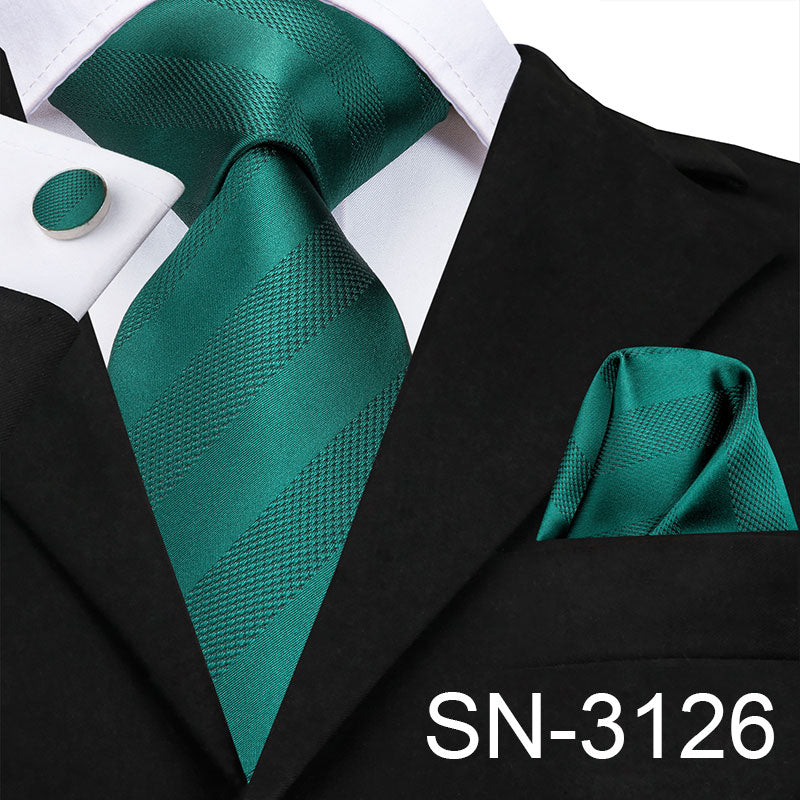 Light blue silk men's necktie set with plaid design, matching handkerchief, cufflinks, and accessories for business or wedding attire
