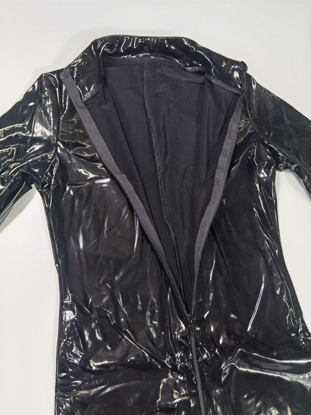 Black and red wetlook PVC catsuit with long sleeves, front zipper, open crotch, stretch fabric, ideal for clubwear or costume use.