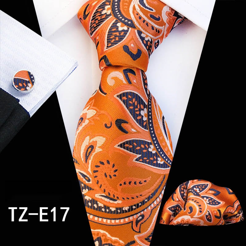 Red and green floral silk tie set with matching handkerchief and cufflinks, stylish accessories for men's business or wedding attire.