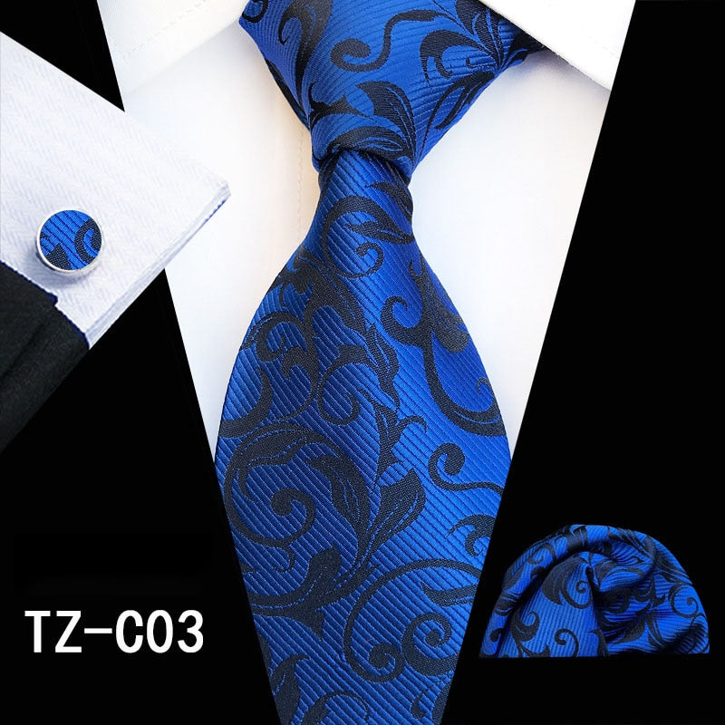 Red and green floral silk tie set with matching handkerchief and cufflinks, stylish accessories for men's business or wedding attire.