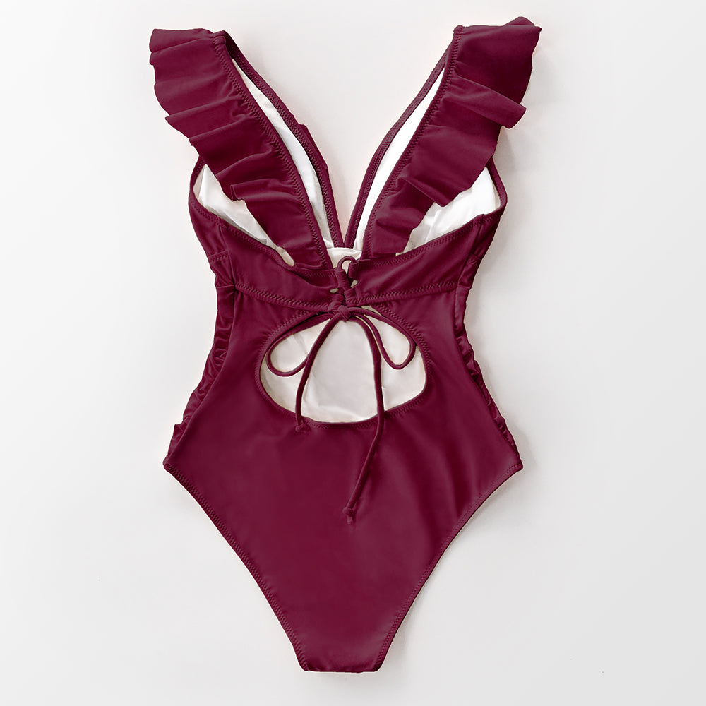 Solid black ruffled one-piece swimsuit with lace-up design, featuring a stylish monokini style for beach and swimwear.