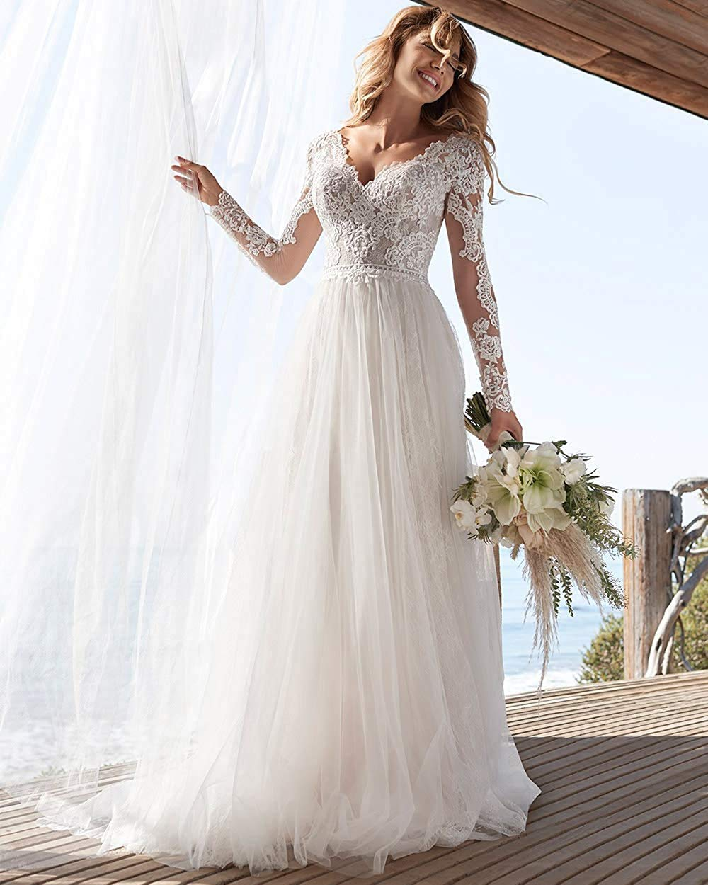 Ivory A-line long sleeve wedding dress with lace and tulle, open back design, by The Clothing Company Sydney.