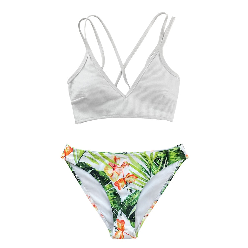 White and green leaf print low-waist bikini set with lace-up front, two-piece swimsuit suitable for beach and swimming.