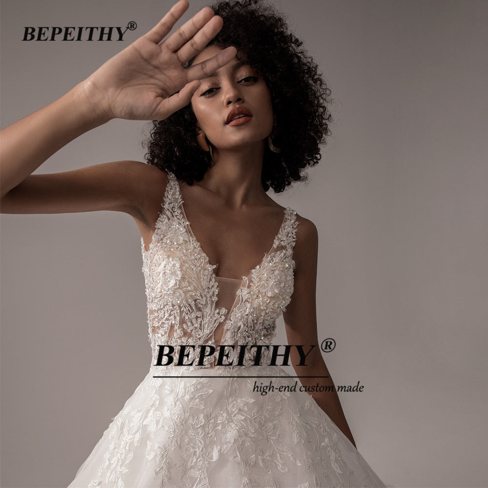 Ivory V-neck sleeveless wedding dress with lace, A-line silhouette, romantic boho bridal gown by The Clothing Company Sydney.