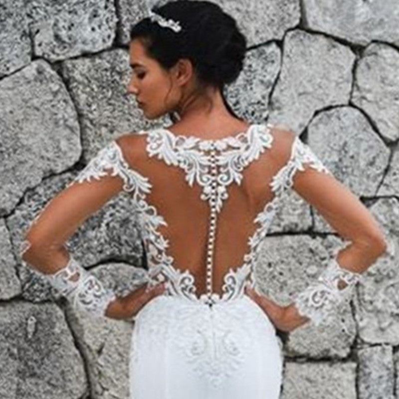 Elegant scoop mermaid wedding dress by The Clothing Company Sydney with long sleeves, illusion back, lace appliqué, and train.