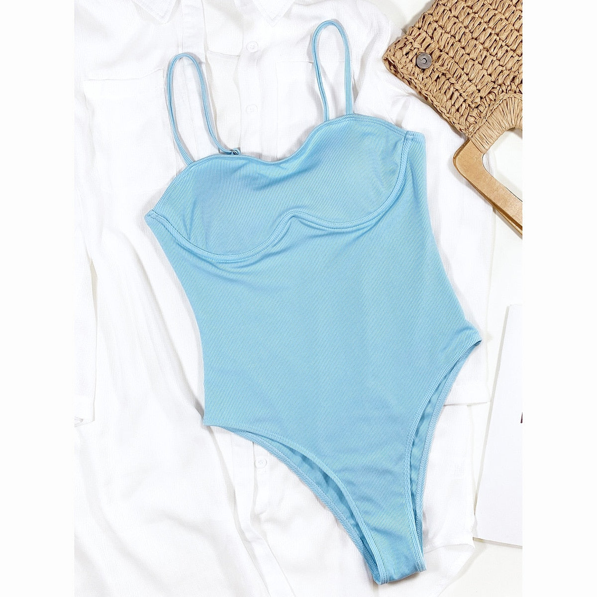 Solid blue one-piece swimsuit by The Clothing Company Sydney featuring a thong monokini design, perfect for beachwear and swimming.