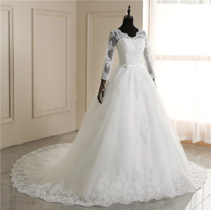 Long sleeve white wedding dress with lace appliques, V-neck, princess style, plus size bridal gown by The Clothing Company Sydney.