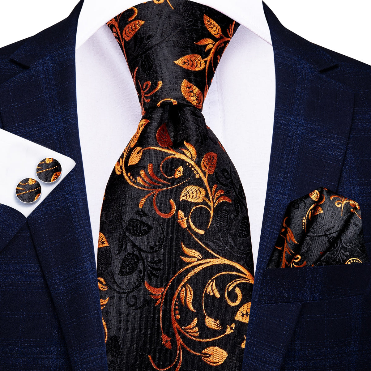 Three men's silk accessories including a paisley tie, pocket square, and cufflinks, in elegant formal style.