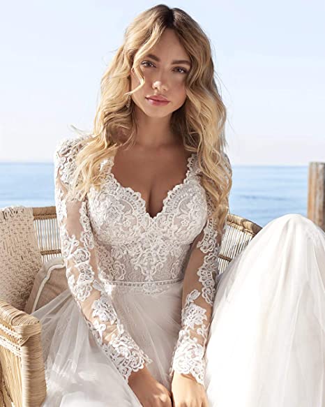 Ivory A-line long sleeve wedding dress with lace details, tulle fabric, and open back from The Clothing Company Sydney.