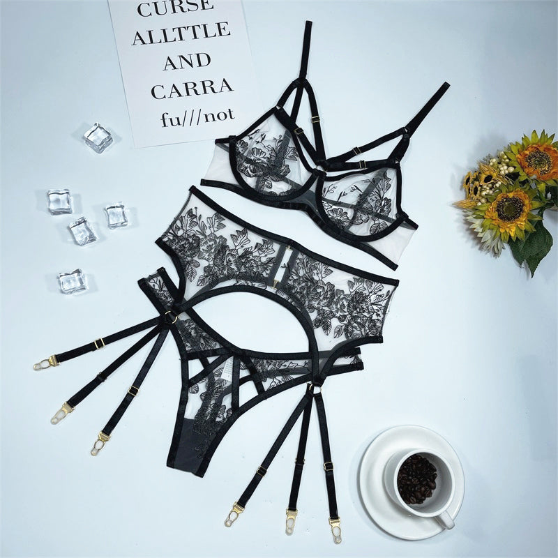 Elegant 3-piece lingerie set with lace embroidery, transparent briefs, and garters from The Clothing Company Sydney.