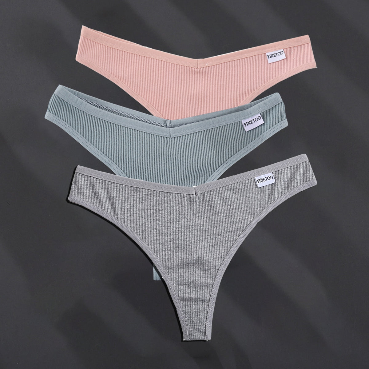 Three cotton G-string panties from The Clothing Company Sydney in solid colors, showcasing comfortable lingerie and thong design.