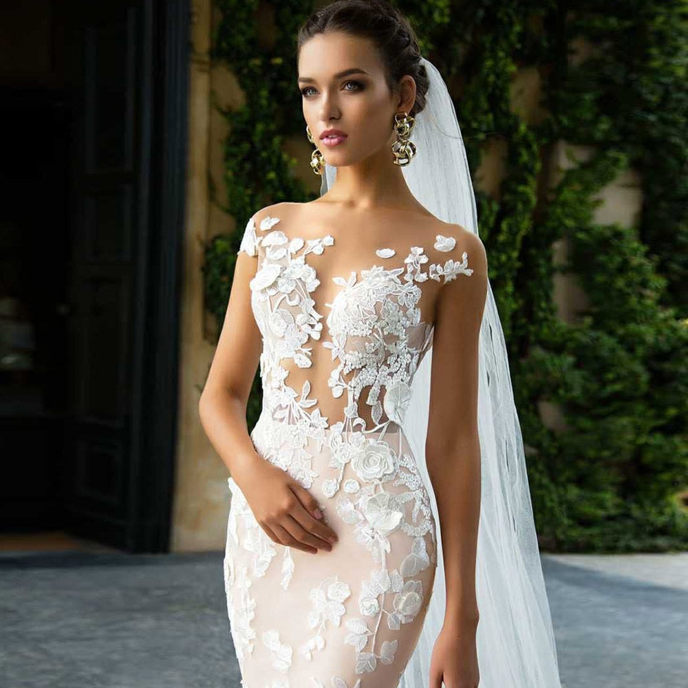 Custom made wedding dress with cap sleeves, backless design, floral appliques, and mermaid silhouette from The Clothing Company Sydney.