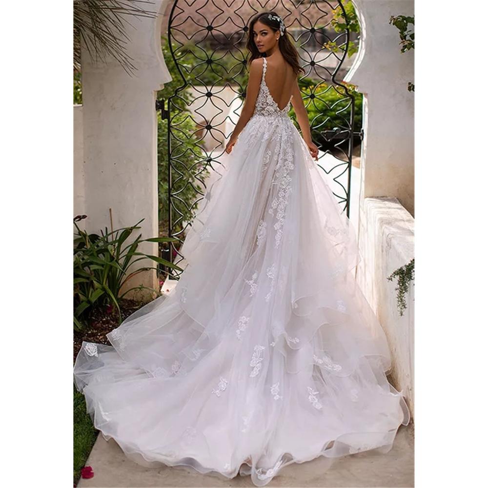 Long boho A-line backless wedding dress with 3D floral details, spaghetti straps, and floor-length design from The Clothing Company Sydney.