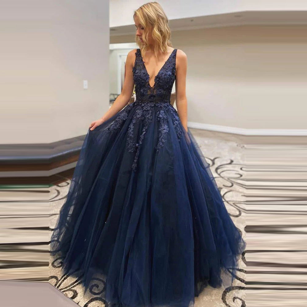Elegant navy blue sleeveless prom dress with lace bodice and A-line silhouette, ideal for formal evening or wedding occasions.