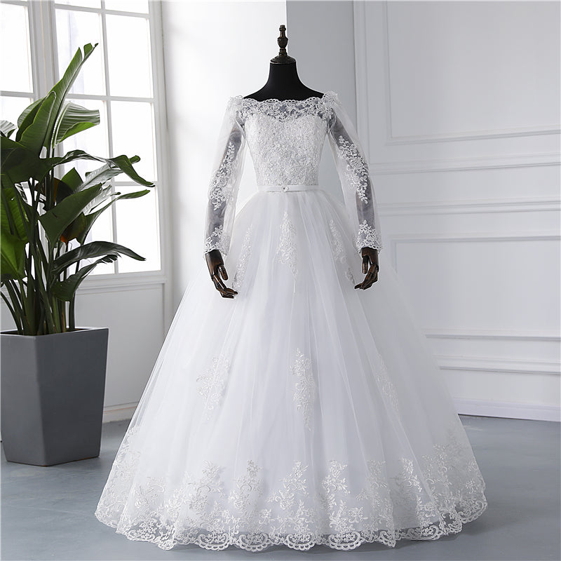Long sleeve white wedding dress with lace appliques, V-neck, flowing silhouette, from The Clothing Company Sydney.