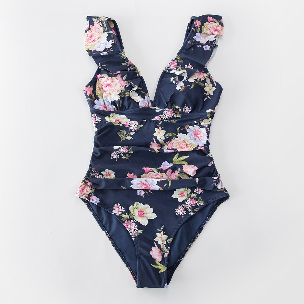 Solid black ruffled one-piece swimsuit by The Clothing Company Sydney featuring lace-up design and stylish beach-ready monokini fit.