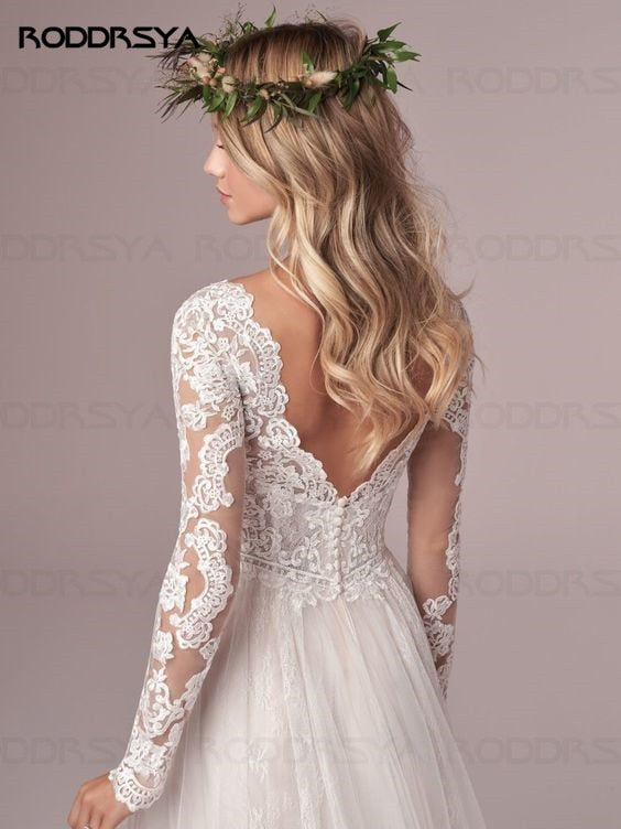 Ivory A-line long sleeve wedding dress with lace details, tulle fabric, and open back design by The Clothing Company Sydney.