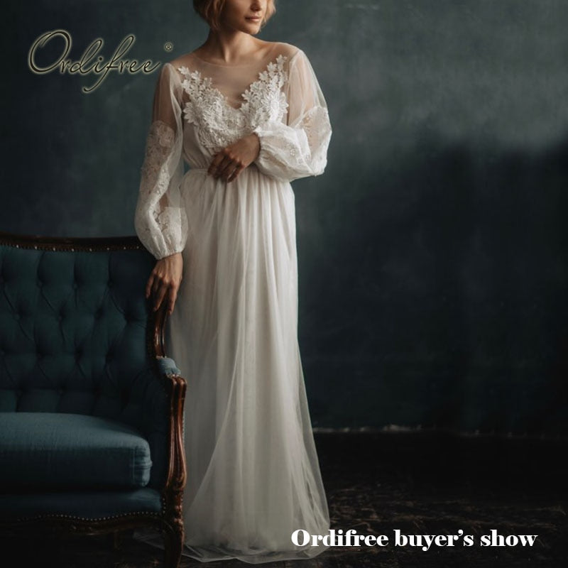 White long sleeve tulle wedding dress with embroidery and lace details, perfect for summer vacations and beach occasions.