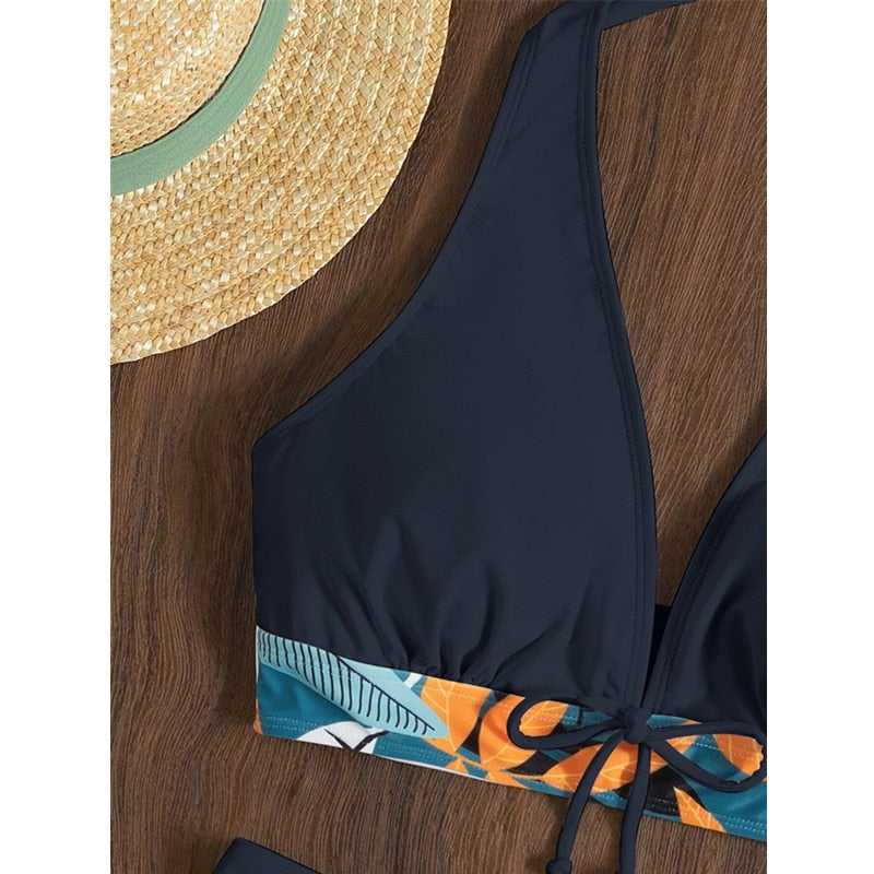 Two-piece swimsuit bikini set by The Clothing Company Sydney featuring a lace print, high waist, halter neck, and deep V-neck design.