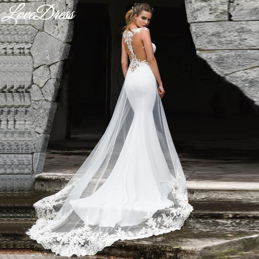 See-through back mermaid wedding dress by The Clothing Company Sydney with sleeveless lace appliques for brides.