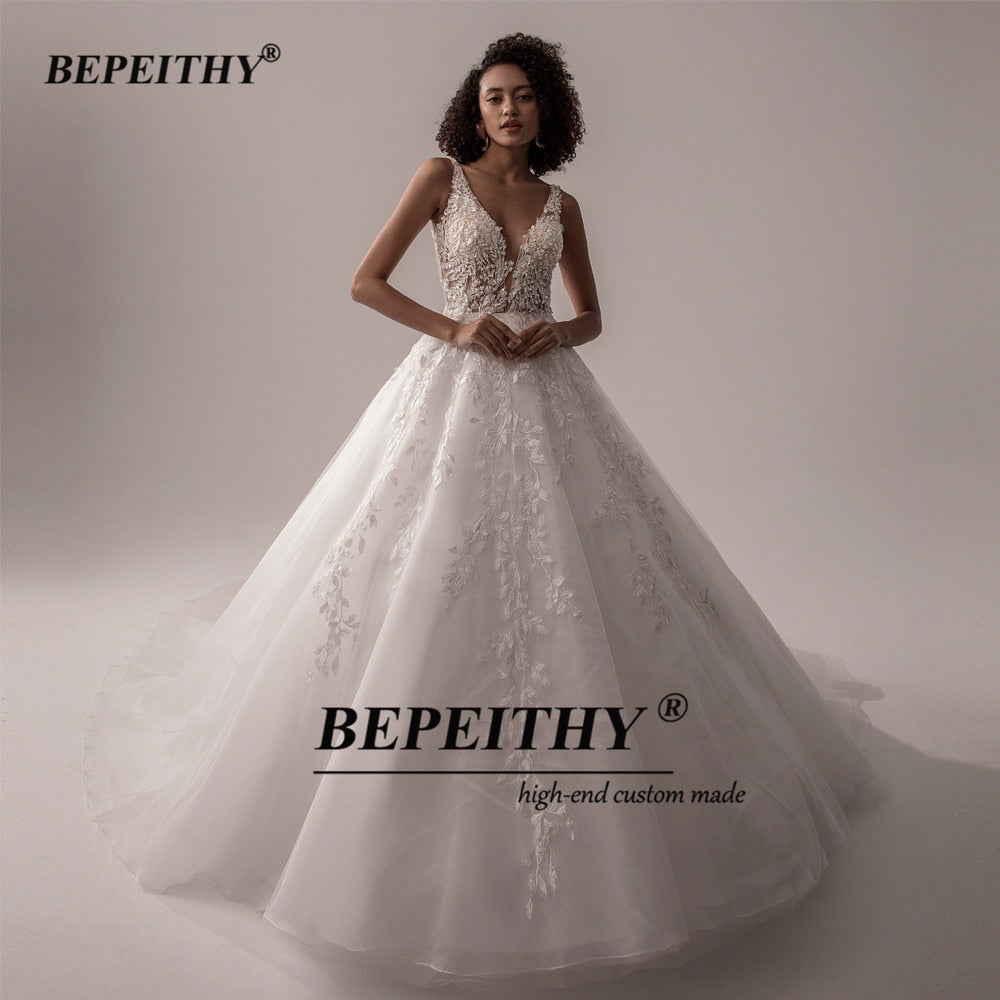 Ivory V-neck sleeveless wedding dress with lace details, A-line silhouette, romantic boho bridal gown from The Clothing Company Sydney