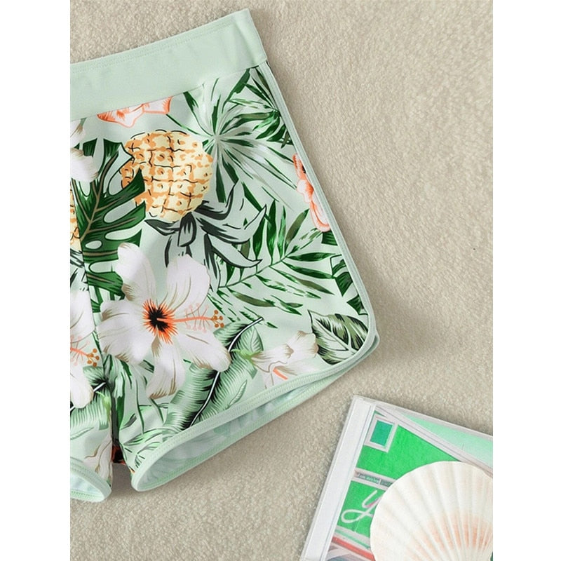 Two-piece swimsuit bikini top with lace print, high waist, halter neck, deep V-neck, and backless design by The Clothing Company Sydney.