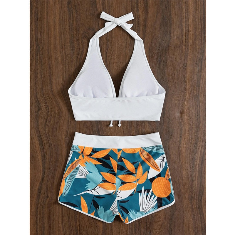 Two-piece bikini swimsuit by The Clothing Company Sydney featuring a lace print, high waist, halter neck, and deep V-neck backless design.