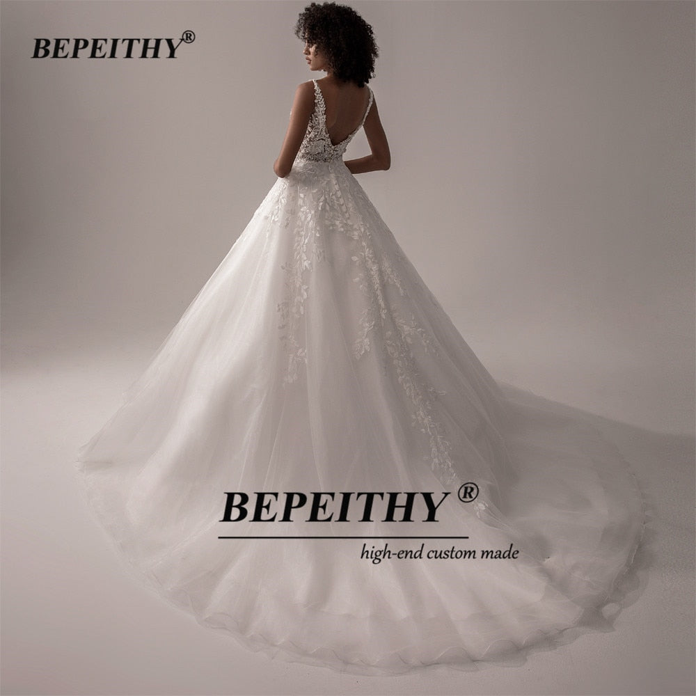Ivory V-neck sleeveless wedding dress with lace details, A-line silhouette, romantic boho bridal gown from The Clothing Company Sydney