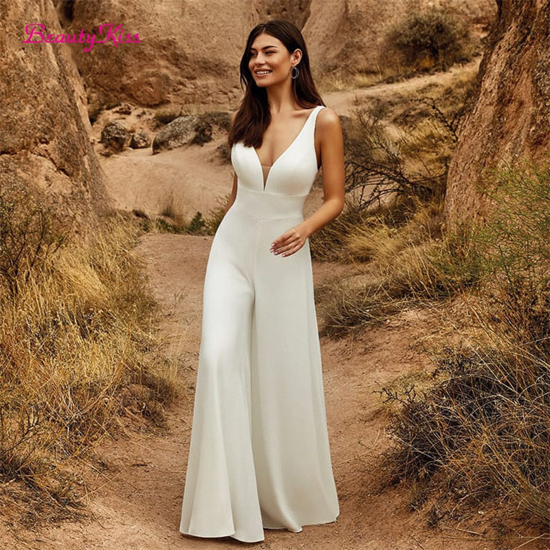 Elegant 2-in-1 wedding jumpsuit with detachable skirt, tulle fabric, V-neck, and sweep train from The Clothing Company Sydney.