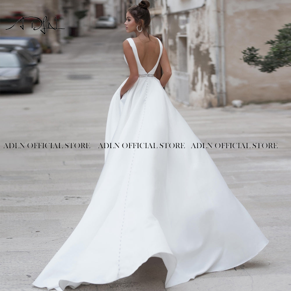 Elegant white satin wedding dress with V-neck and backless design, custom-made bridal gown from The Clothing Company Sydney.