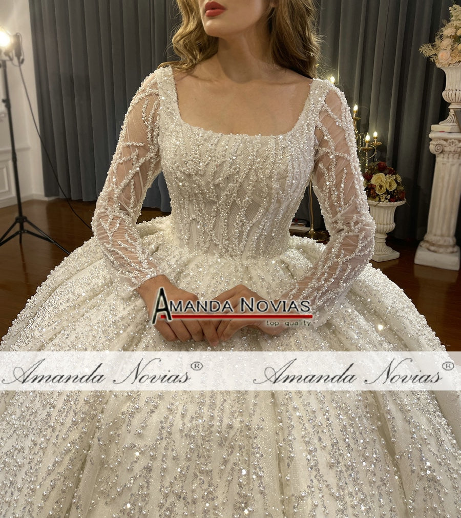 Long sleeve luxury beaded bridal wedding dress with intricate beadwork and elegant silhouette by The Clothing Company Sydney.