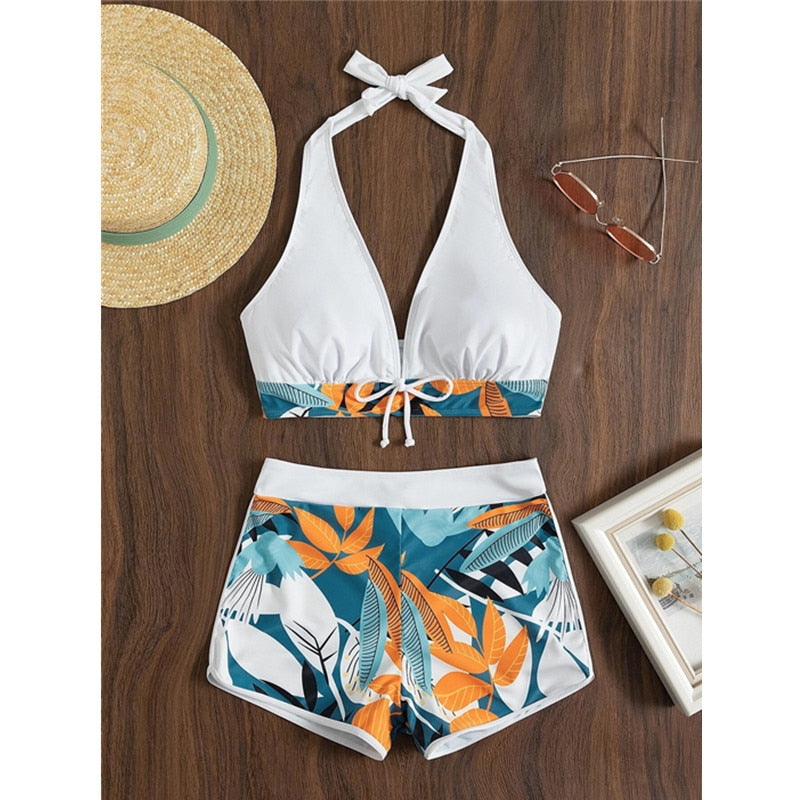 Two-piece bikini swimsuit with lace print, high waist, halter neck, deep V-neck, and backless design by The Clothing Company Sydney.