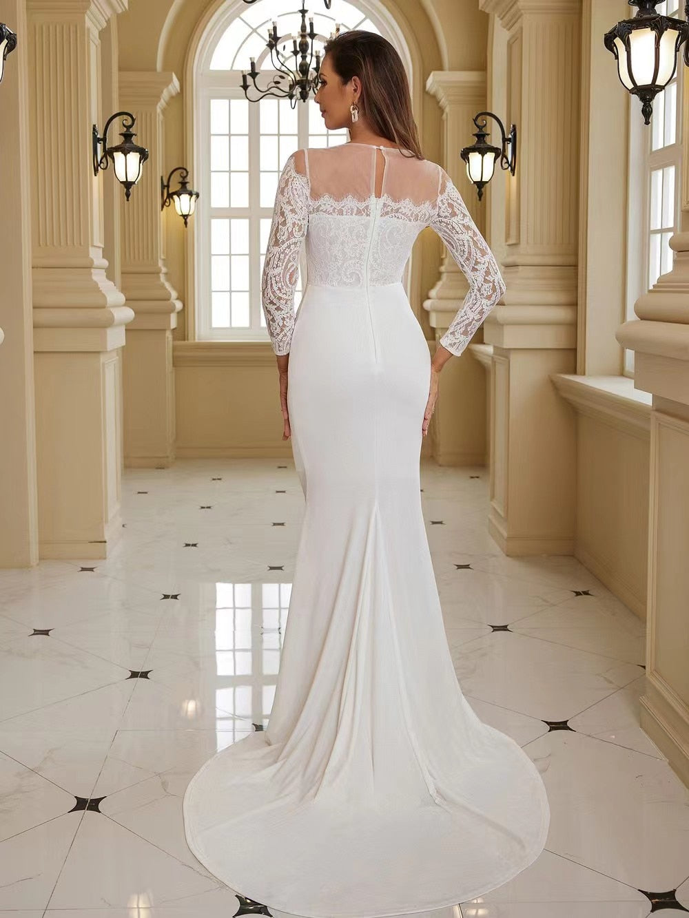 Elegant white wedding dress by The Clothing Company Sydney featuring long sleeves, a fitted bodice, and a flowing train.