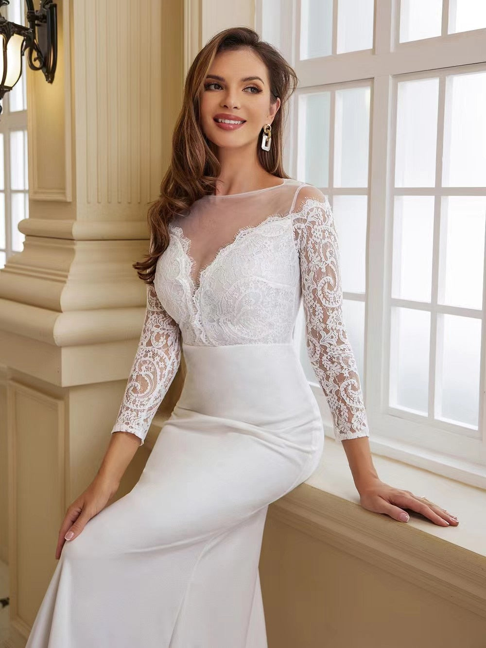 Elegant white wedding dress for bride with long sleeves and train by The Clothing Company Sydney, featuring intricate lace details.