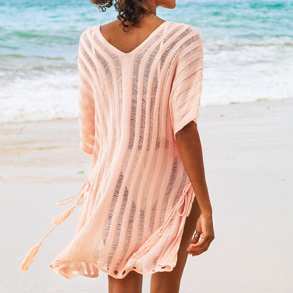 Pink V-neck crochet mini dress with bat sleeves, loose fit, hollow out design, perfect as a casual beach cover-up by The Clothing Company Sydney.