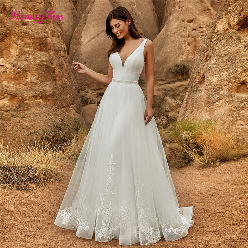 Elegant 2-in-1 wedding jumpsuit with detachable skirt, tulle fabric, V-neck, sweep train, bridal dress by The Clothing Company Sydney.
