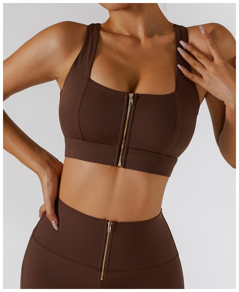 Two-piece women's yoga set by The Clothing Company Sydney, featuring high waist leggings, a skirt, and a zip sports bra for fitness.
