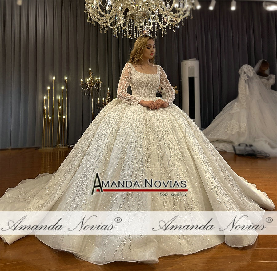Long sleeve luxury beaded bridal wedding dress by The Clothing Company Sydney, featuring intricate beadwork and elegant silhouette.