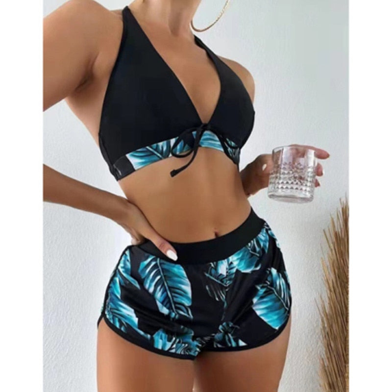 Two-piece bikini swimsuit by The Clothing Company Sydney with lace print, high waist, halter neck, deep V-neck, and backless design.