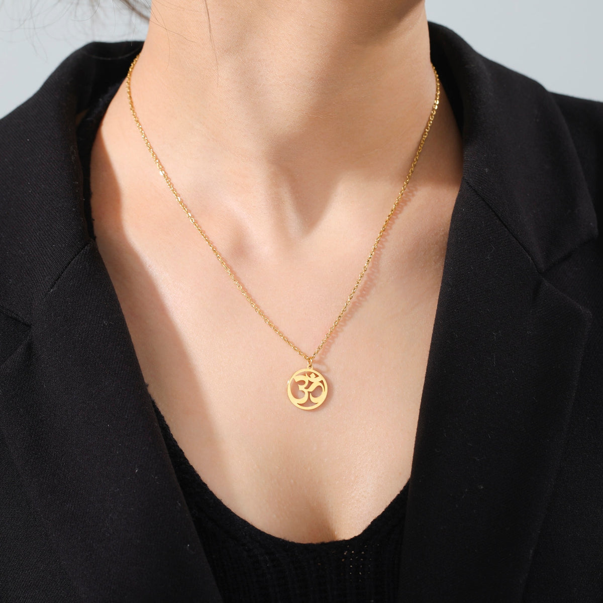 Stainless steel Tamil Om Aum symbol pendant with trident design on a chain, vintage yoga-inspired jewelry piece.