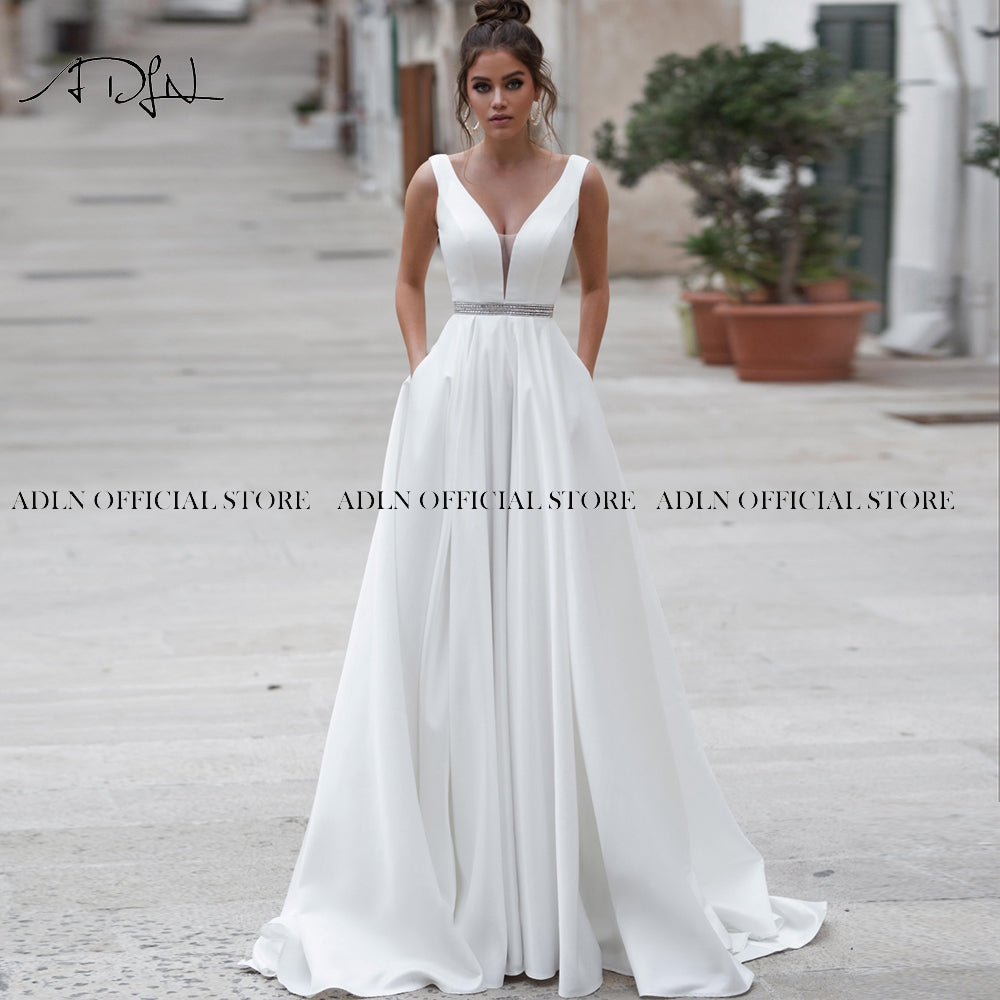 Elegant satin wedding dress with V-neck and backless design, custom-made by The Clothing Company Sydney, in white ivory.