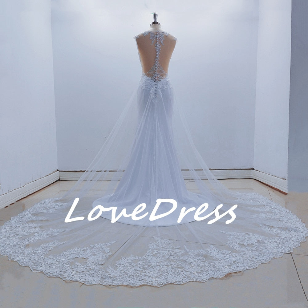 See-through back mermaid wedding dress by The Clothing Company Sydney with sleeveless lace appliques for brides.