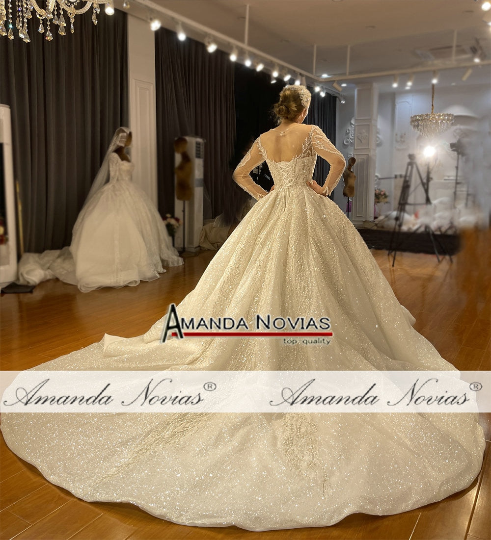Elegant long sleeve ball gown wedding dress by The Clothing Company Sydney, featuring intricate lace details and a flowing skirt.